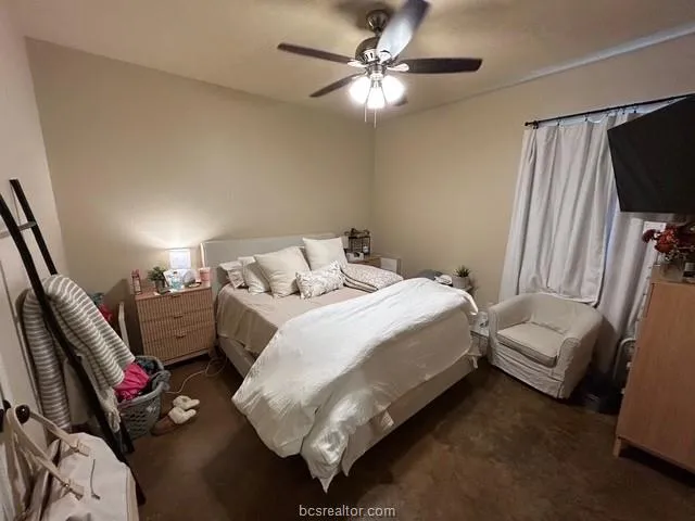 a bedroom with a bed furniture and a flat screen tv