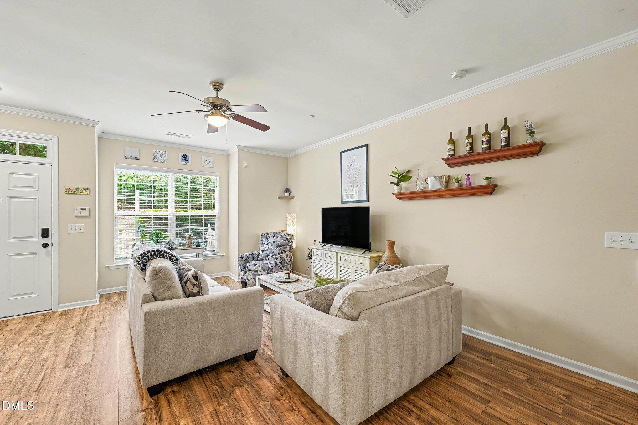 1130 Renewal Place, Unit 106 Raleigh, NC 27603 - Photo 4 of 34 a living room with furniture and a flat screen tv