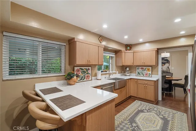 a kitchen with a stove a refrigerator and a dining table