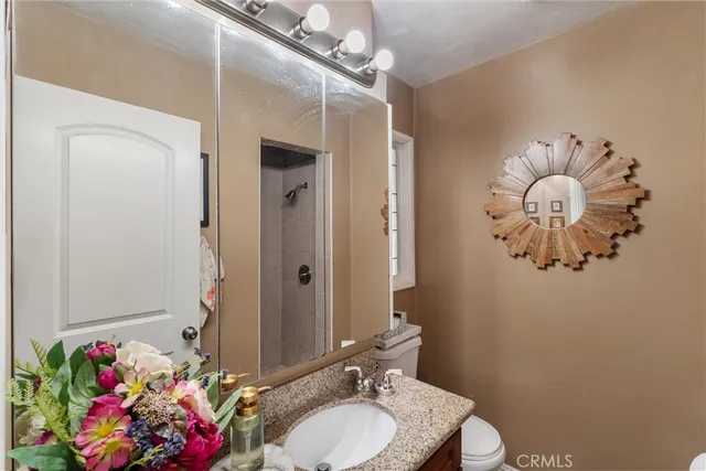 a bathroom with a sink mirror and vanity