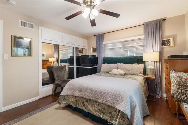 a bedroom with a bed a table and painting