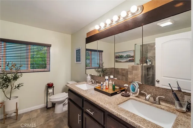a bathroom with a double vanity sink and a mirror