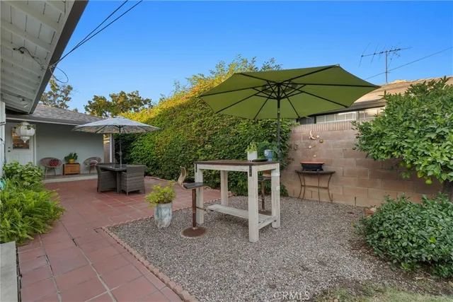 a view of a house with backyard and sitting area