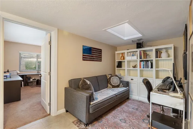 a living room with furniture and a book shelf