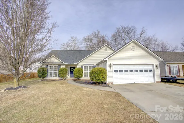 a view of a house with a yard and garage