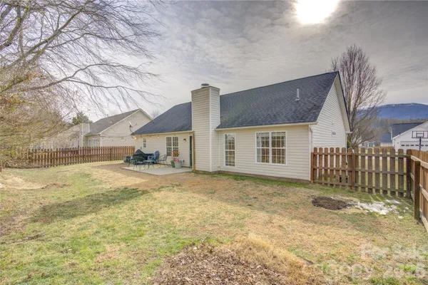 a view of a house with a yard covered in snow