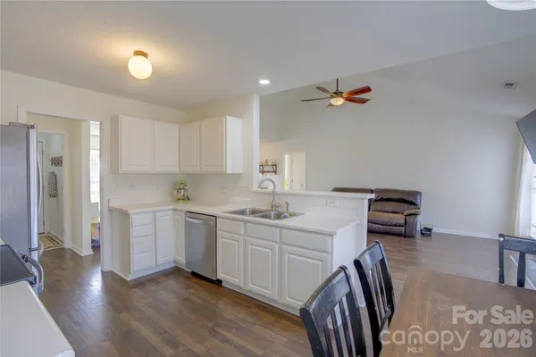 a kitchen with a sink appliances and cabinets