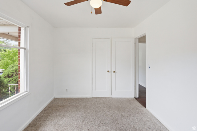 774 37th Street South Ogden, UT 84403 - Photo 15 of 47 Neutral-toned carpeting paired with white walls, featuring a ceiling fan with integrated lighting