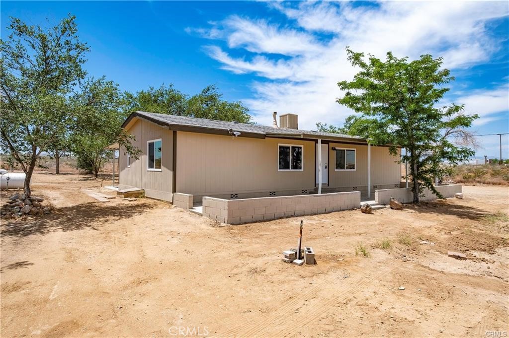 12782 Atsina Road Phelan, CA 92371 - Photo 1 of 18 a backyard of a house with table and chairs