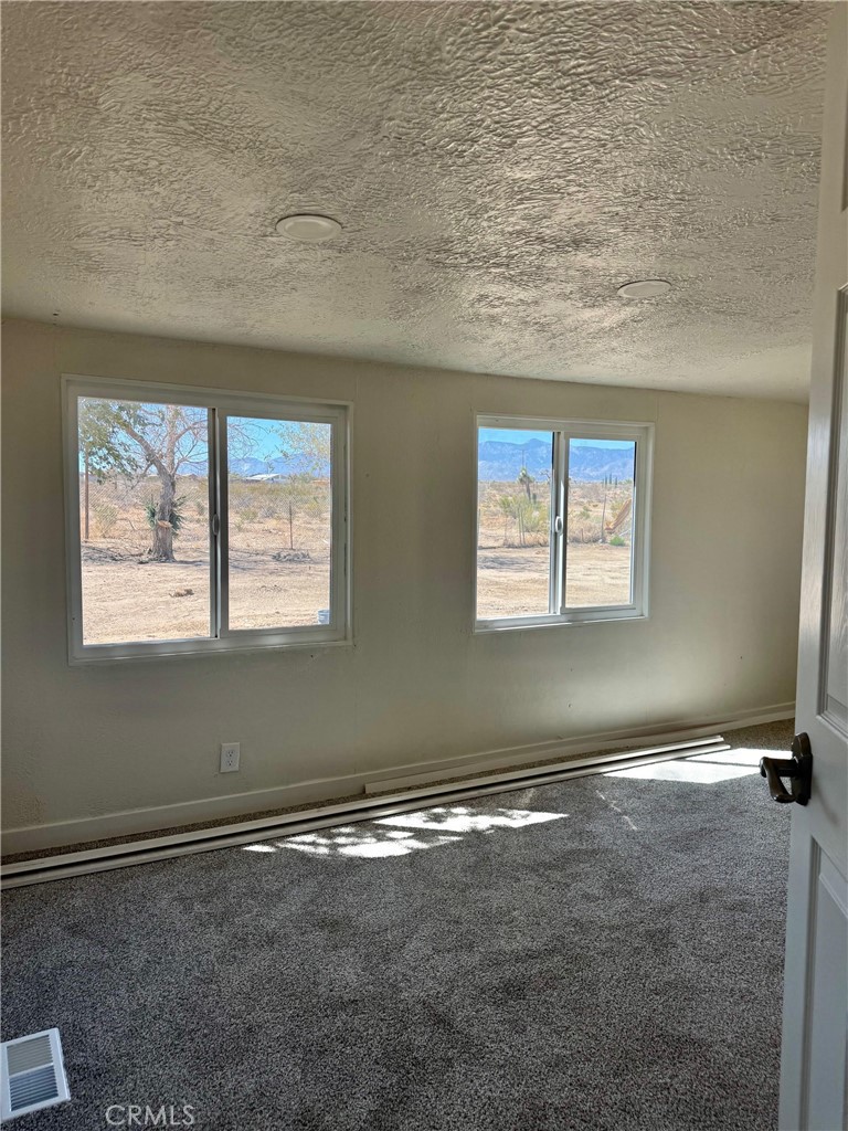 12782 Atsina Road Phelan, CA 92371 - Photo 14 of 18 an empty room with windows