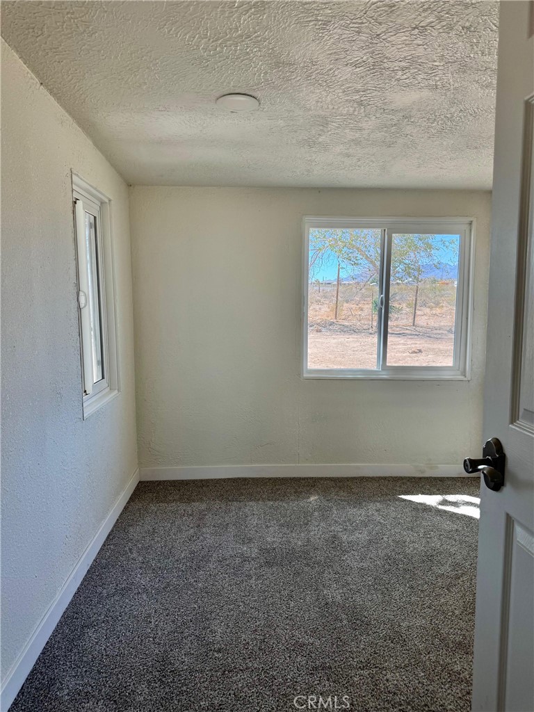 12782 Atsina Road Phelan, CA 92371 - Photo 15 of 18 an empty room with windows