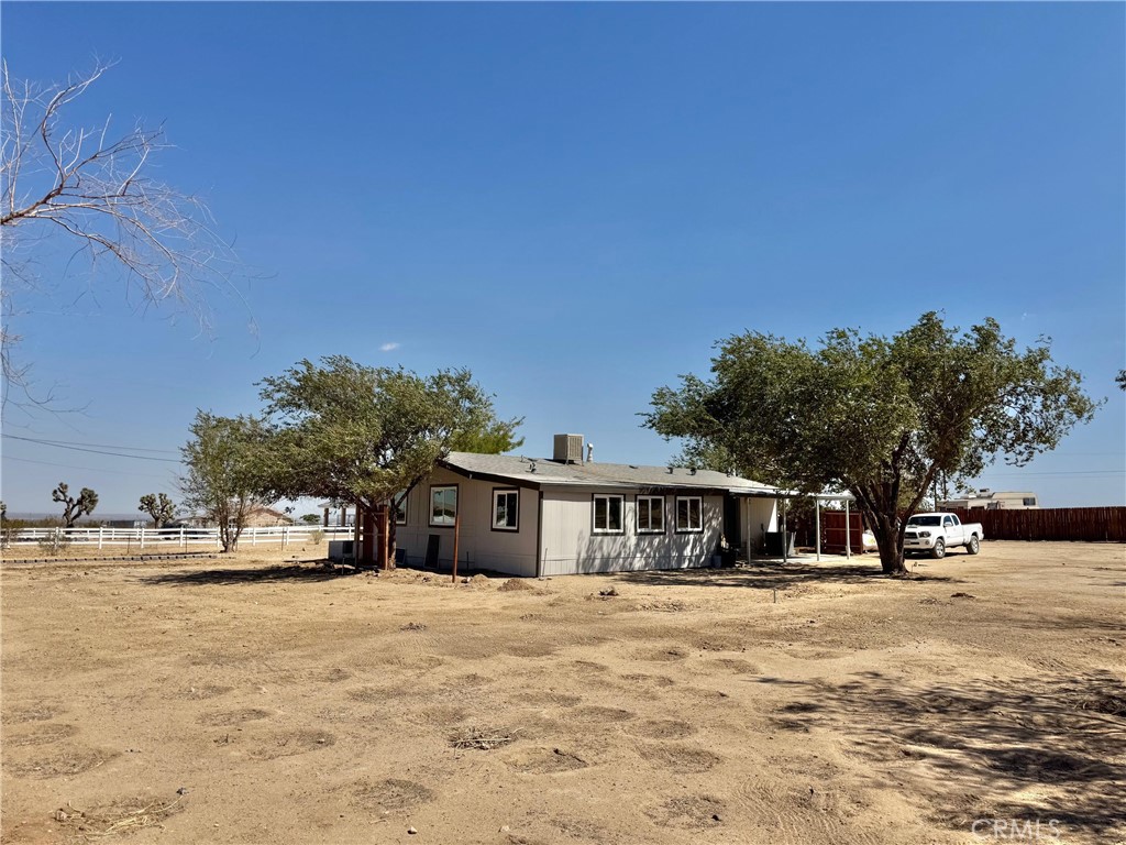 12782 Atsina Road Phelan, CA 92371 - Photo 16 of 18 a front view of a house with a yard