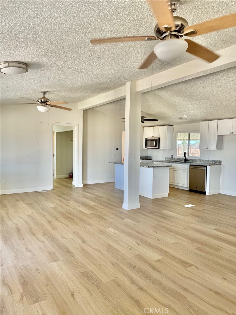 12782 Atsina Road Phelan, CA 92371 - Photo 7 of 18 a view of a kitchen with a sink and a stove