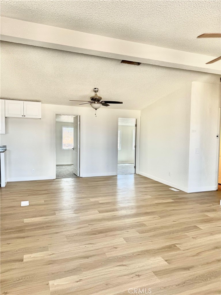 12782 Atsina Road Phelan, CA 92371 - Photo 8 of 18 a view of a room with wooden floor and cabinet