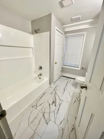 a bathroom with a bathtub and a shower