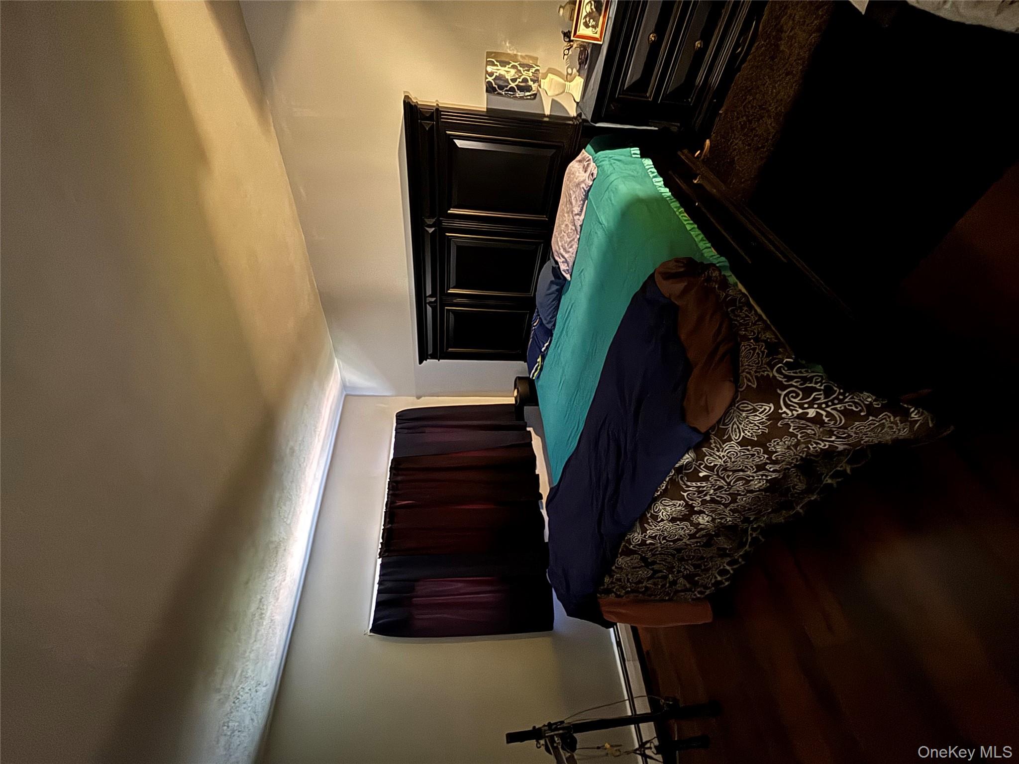 59 Windmill Road Hyde Park, NY 12601 - Photo 8 of 13 Bedroom with dark wood-style floors and a baseboard radiator