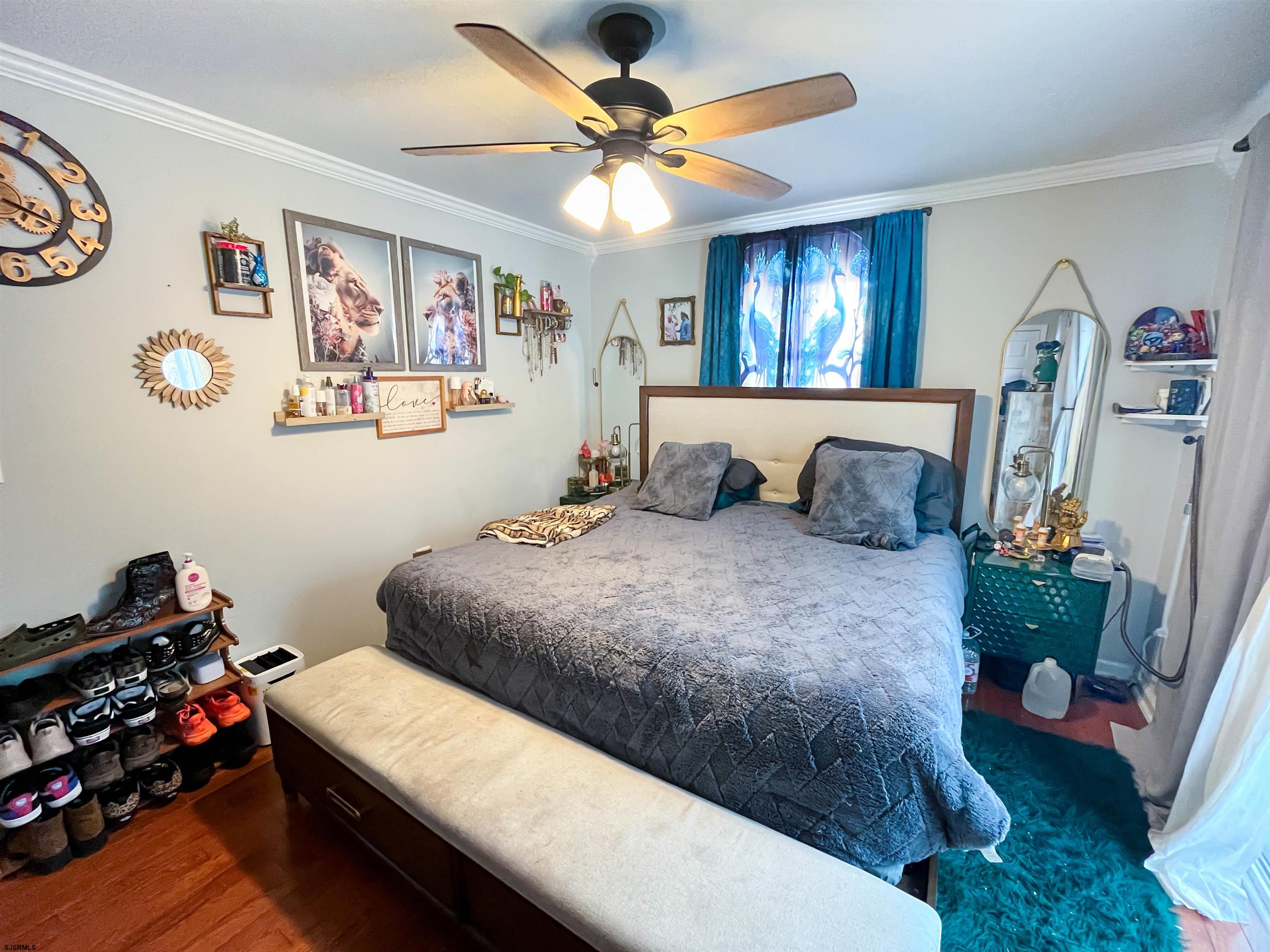 522 Zion Road Egg Harbor Township, NJ 08234 - Photo 14 of 42 a bedroom with a bed and a chandelier