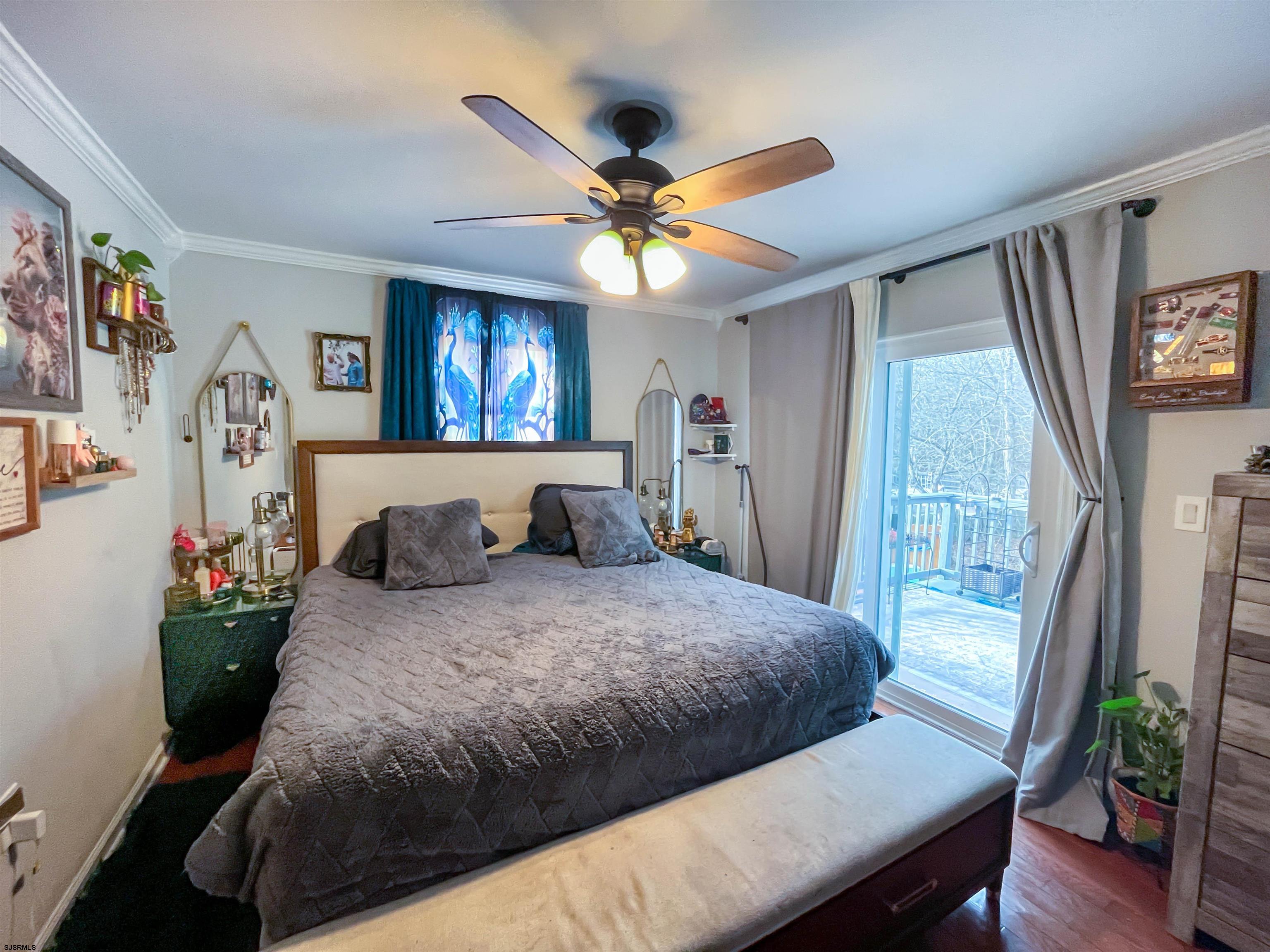 522 Zion Road Egg Harbor Township, NJ 08234 - Photo 15 of 42 a bedroom with a bed and a chandelier