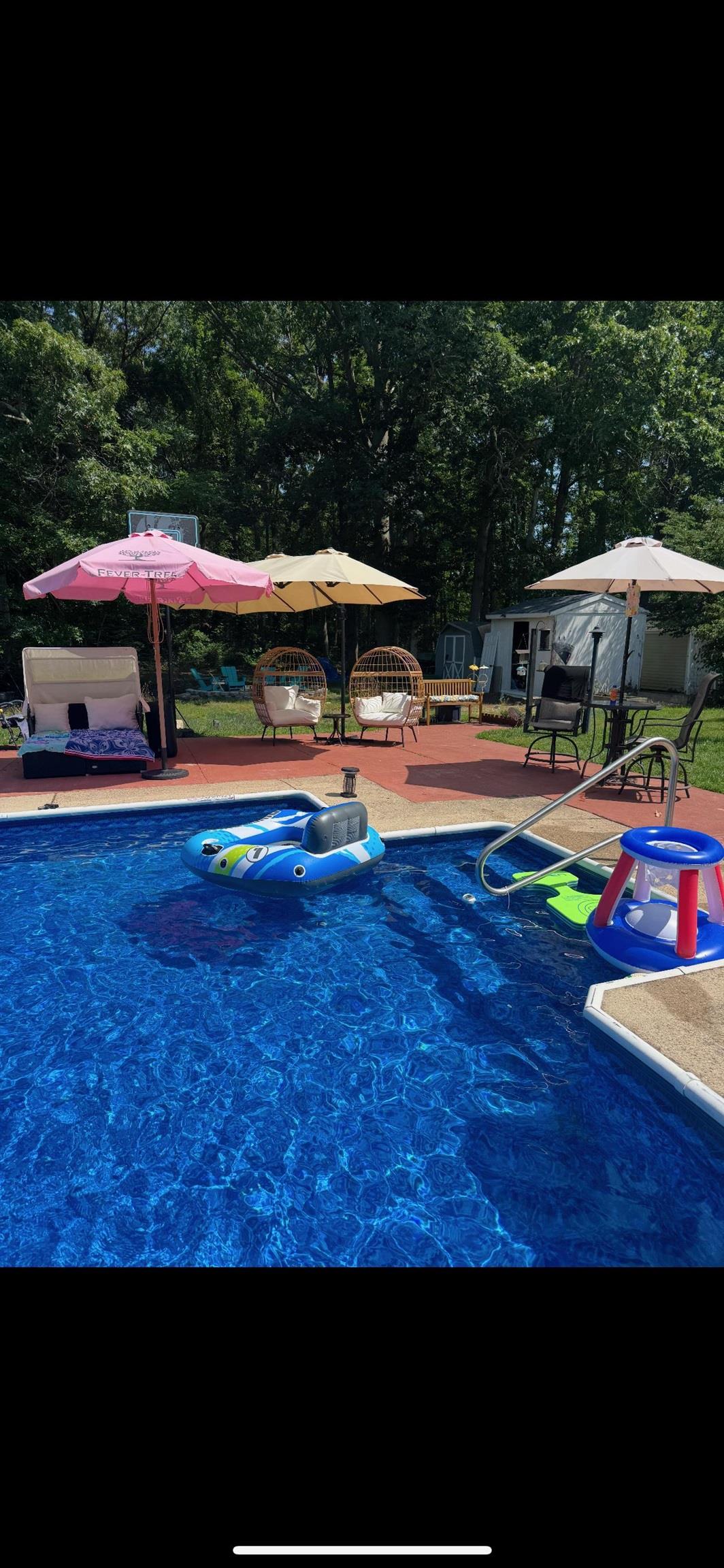 522 Zion Road Egg Harbor Township, NJ 08234 - Photo 40 of 42 a view of pool with lawn chairs under an umbrella