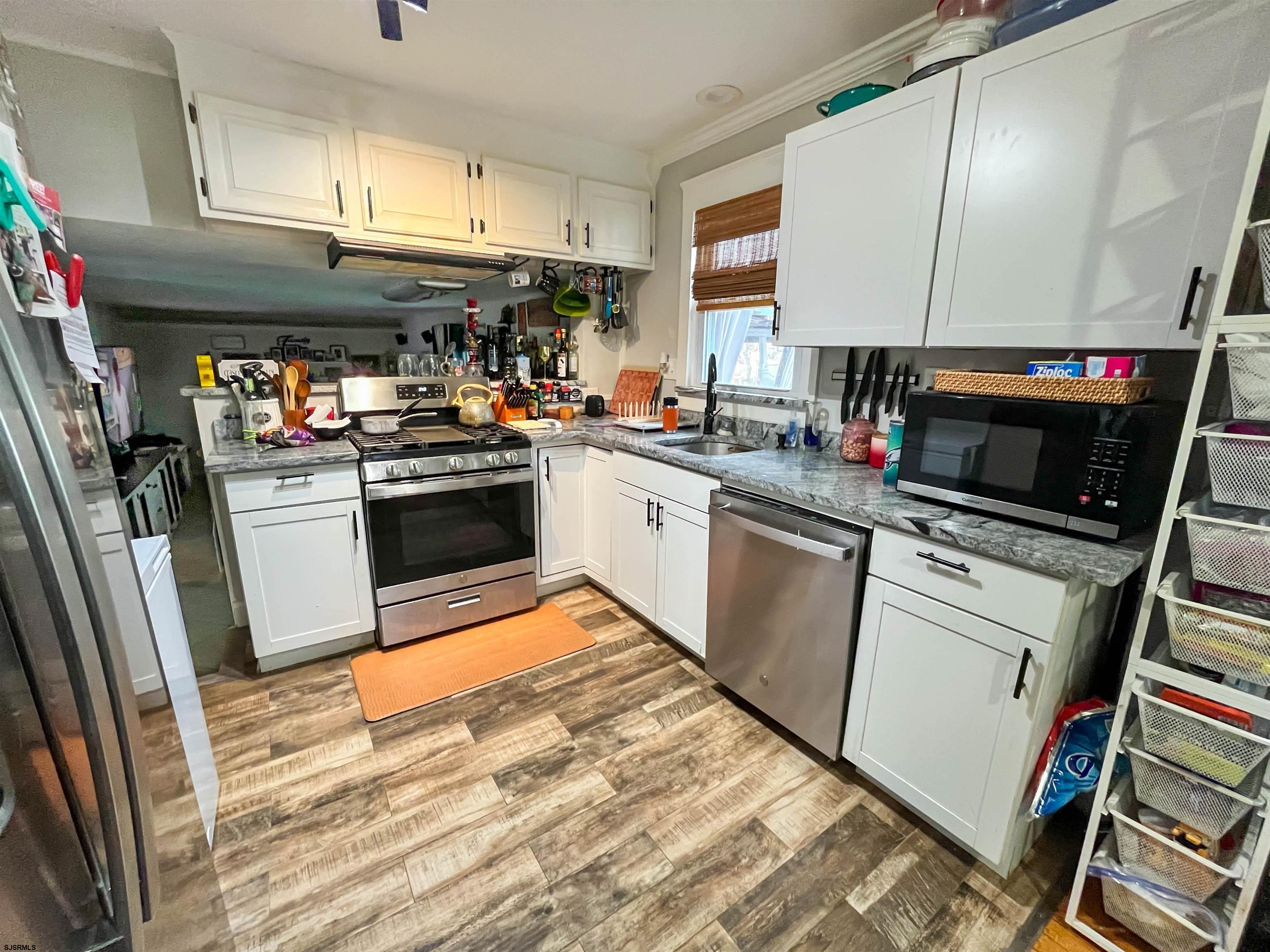 522 Zion Road Egg Harbor Township, NJ 08234 - Photo 9 of 42 a kitchen with stainless steel appliances granite countertop a sink a stove and a refrigerator