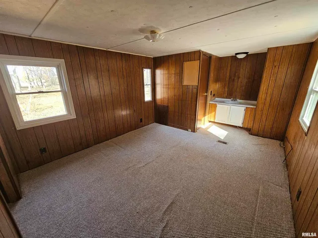 a view of a living room with furniture and floor to ceiling window