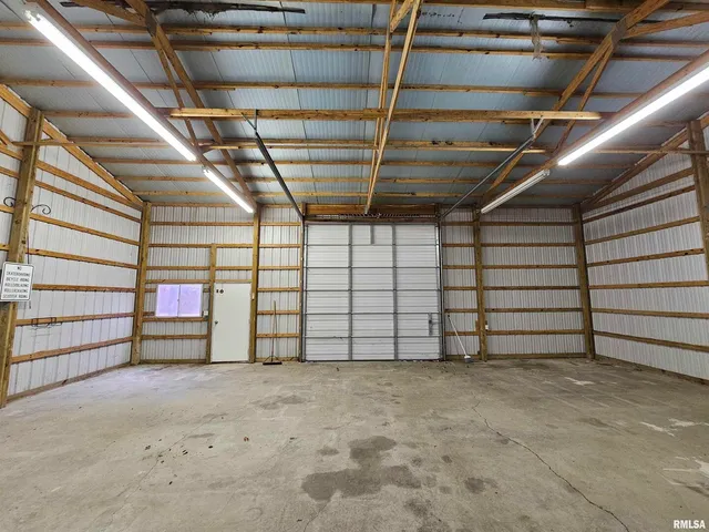 a view of a house with a big yard and large trees
