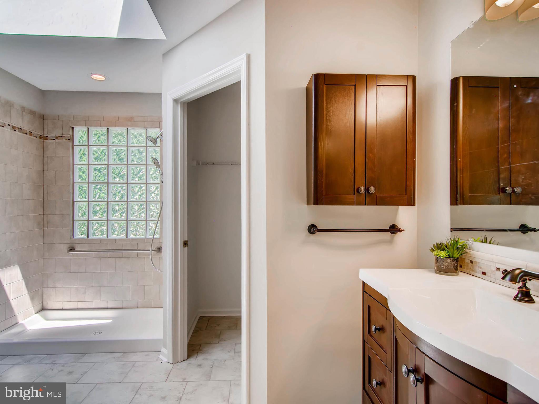 1606 Frederick Road Baltimore, MD 21228 - Photo 15 of 28 a bathroom with a sink and a mirror
