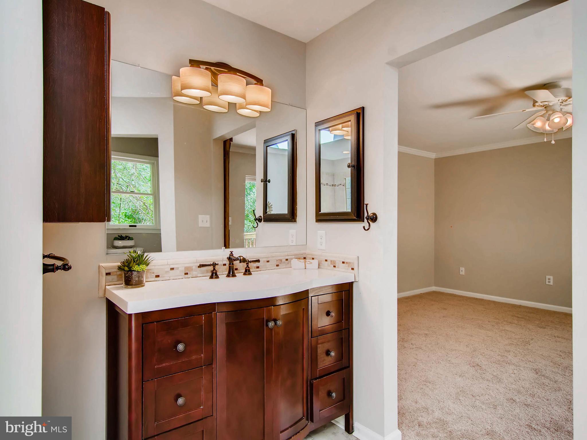 1606 Frederick Road Baltimore, MD 21228 - Photo 16 of 28 a bathroom with a double vanity sink and a mirror