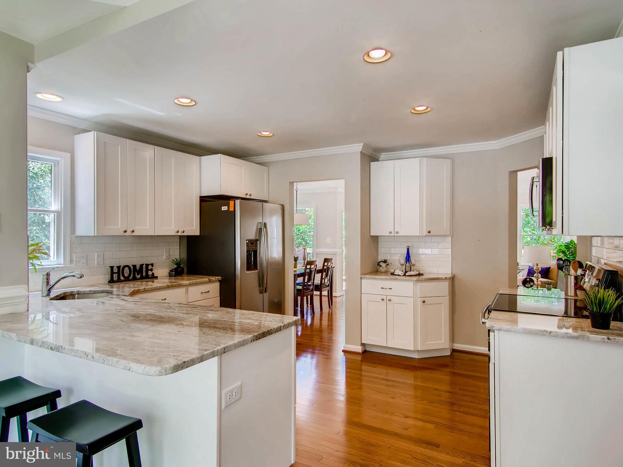 1606 Frederick Road Baltimore, MD 21228 - Photo 3 of 28 a kitchen with stainless steel appliances granite countertop a refrigerator stove microwave and sink