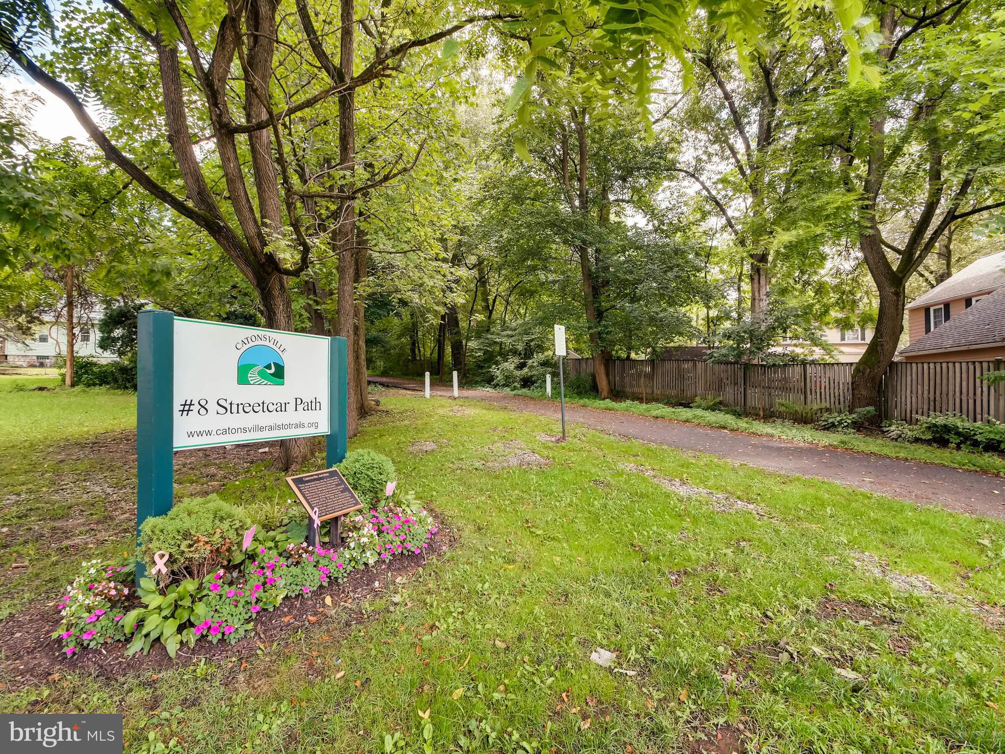 1606 Frederick Road Baltimore, MD 21228 - Photo 27 of 28 a view of a back yard with plants and large trees