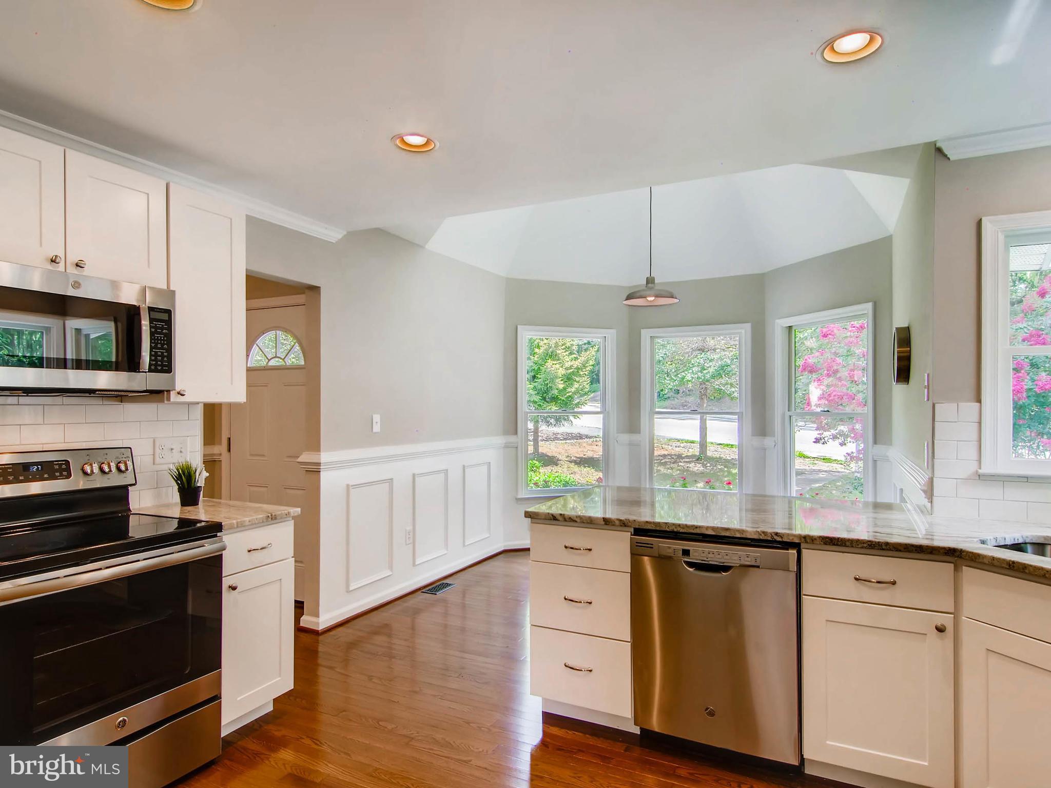 1606 Frederick Road Baltimore, MD 21228 - Photo 6 of 28 a kitchen with granite countertop a stove a sink and a granite counter tops