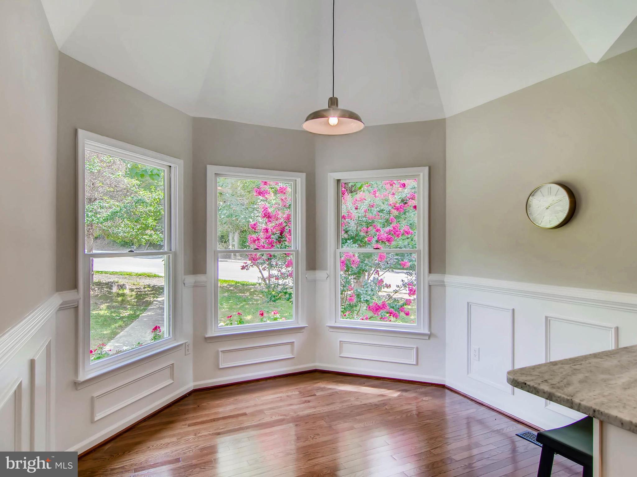 1606 Frederick Road Baltimore, MD 21228 - Photo 7 of 28 a view of an empty room with wooden floor and windows