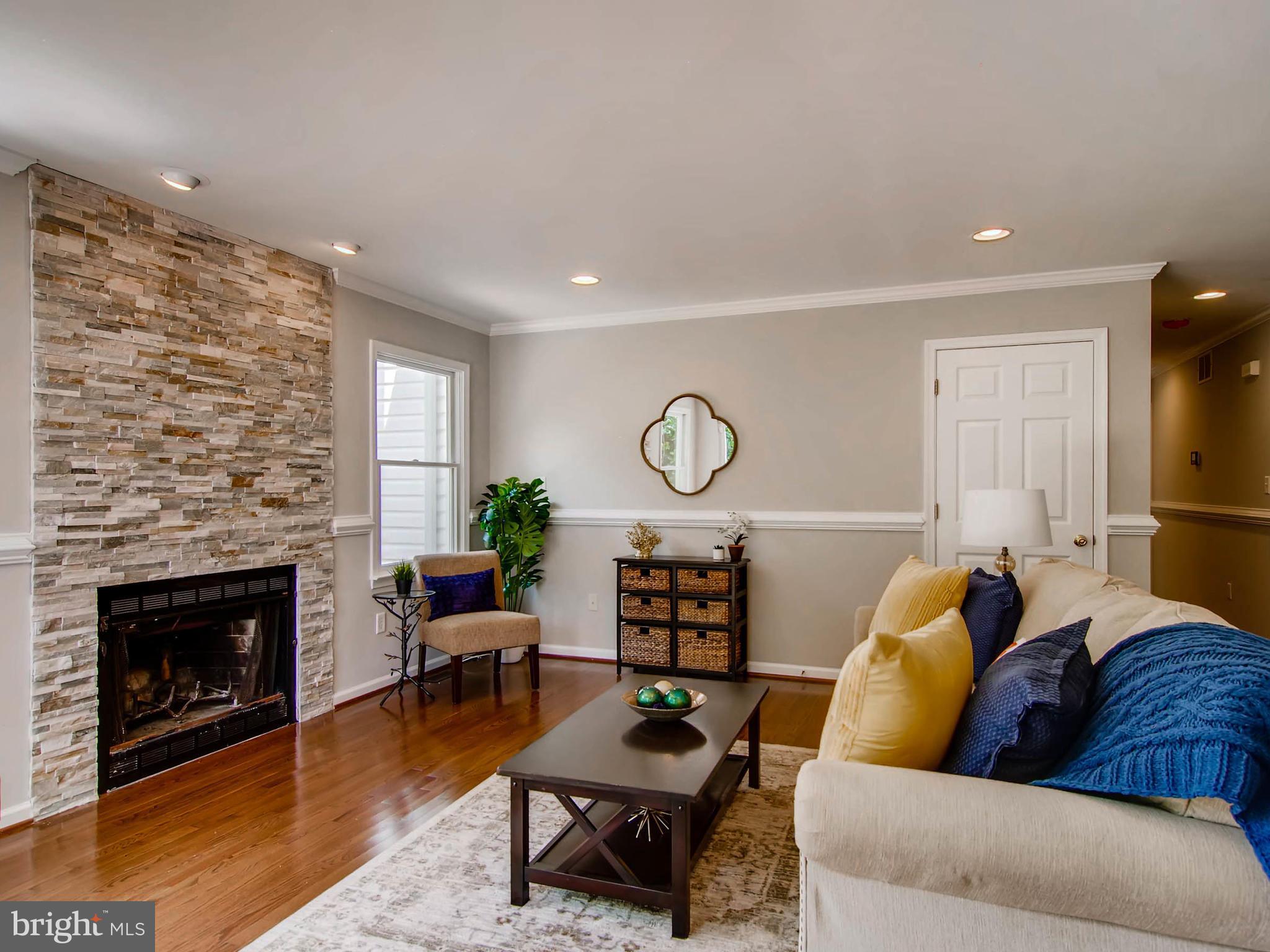 1606 Frederick Road Baltimore, MD 21228 - Photo 9 of 28 a living room with furniture a fireplace and a flat screen tv
