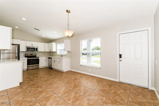 a kitchen with stainless steel appliances granite countertop a refrigerator sink and cabinets