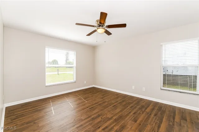wooden floor in an empty room with a window
