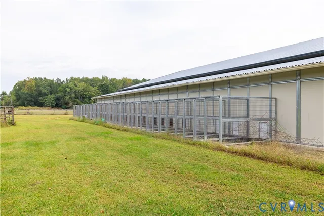 a view of house with swimming pool and green space