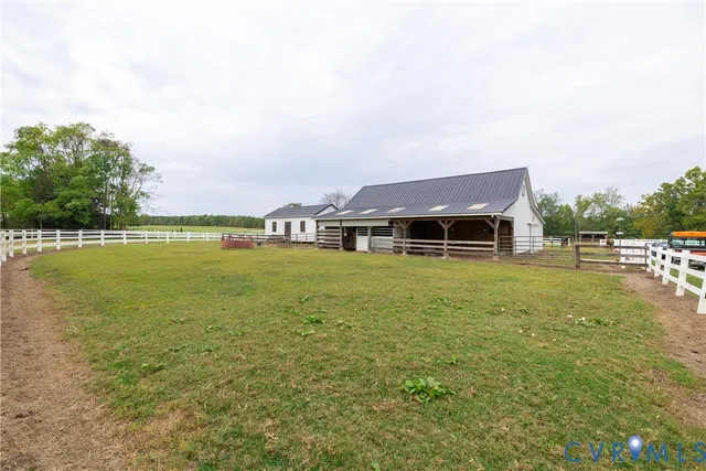 a backyard of a house with lots of green space and lake view