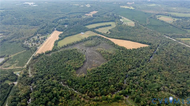 a view of a dry yard with lots of green space