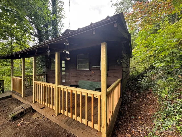 a view of a house with a small yard and wooden floor and fence