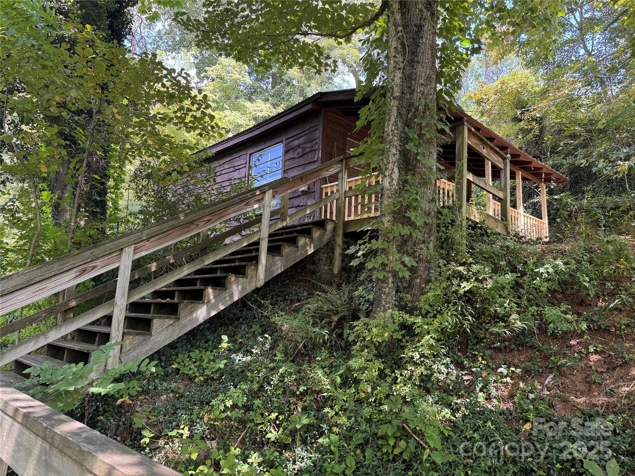 84 Pelohi Cove Road Bryson City, NC 28713 - Photo 21 of 22 a view of a house with a yard balcony and wooden fence