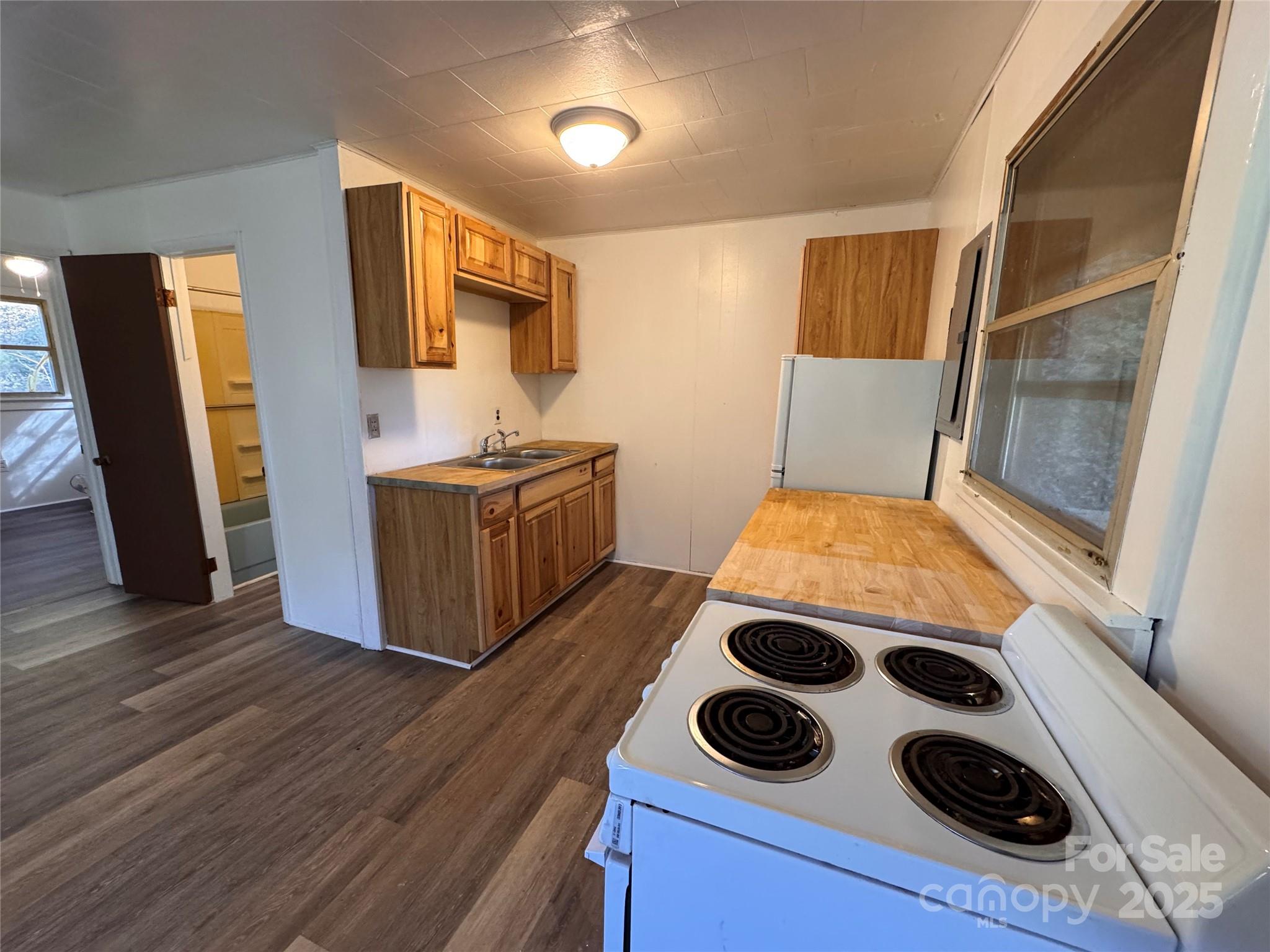 84 Pelohi Cove Road Bryson City, NC 28713 - Photo 6 of 22 a view of kitchen and sink with wooden floor