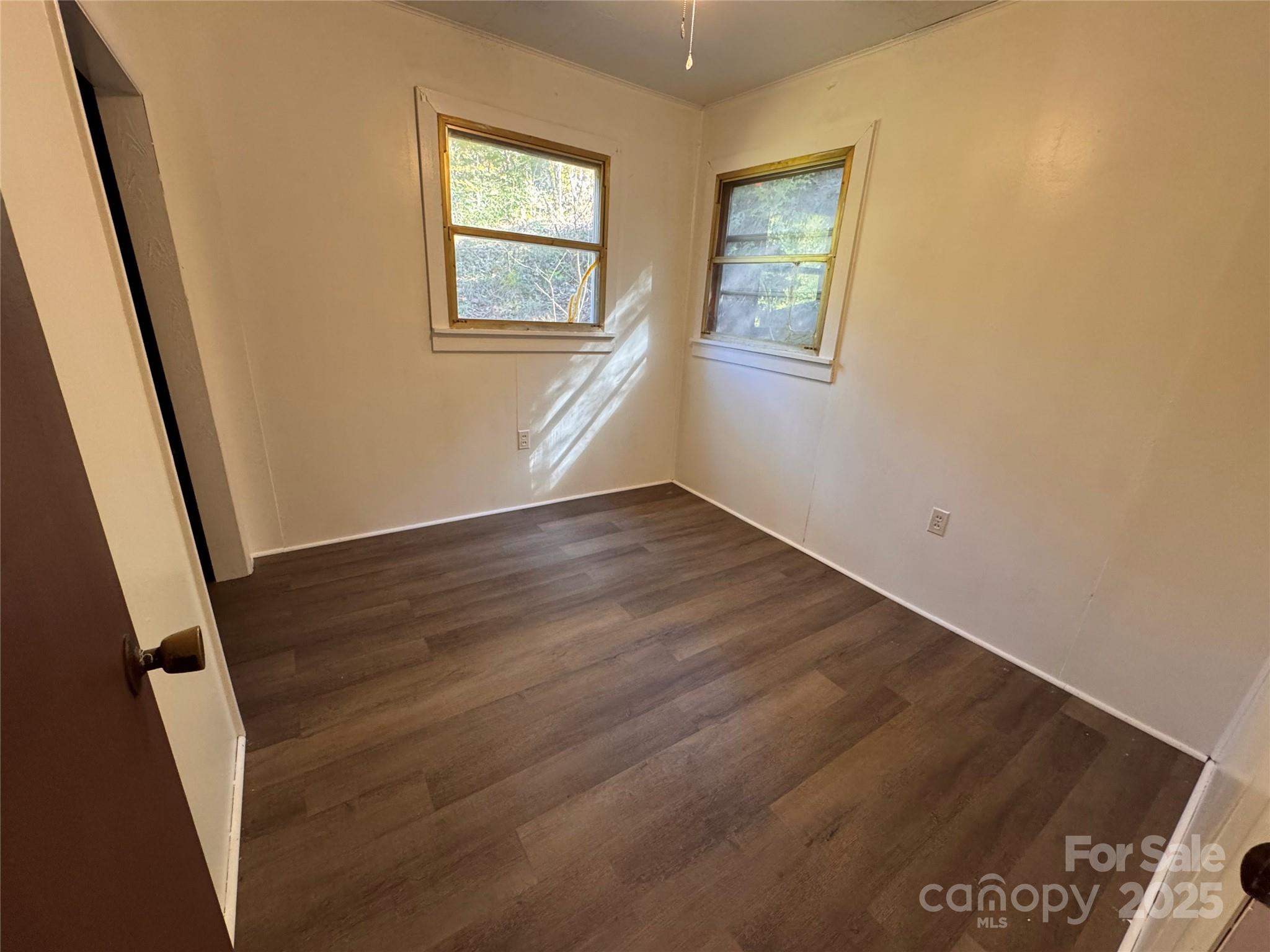 84 Pelohi Cove Road Bryson City, NC 28713 - Photo 9 of 22 an empty room with wooden floor and windows