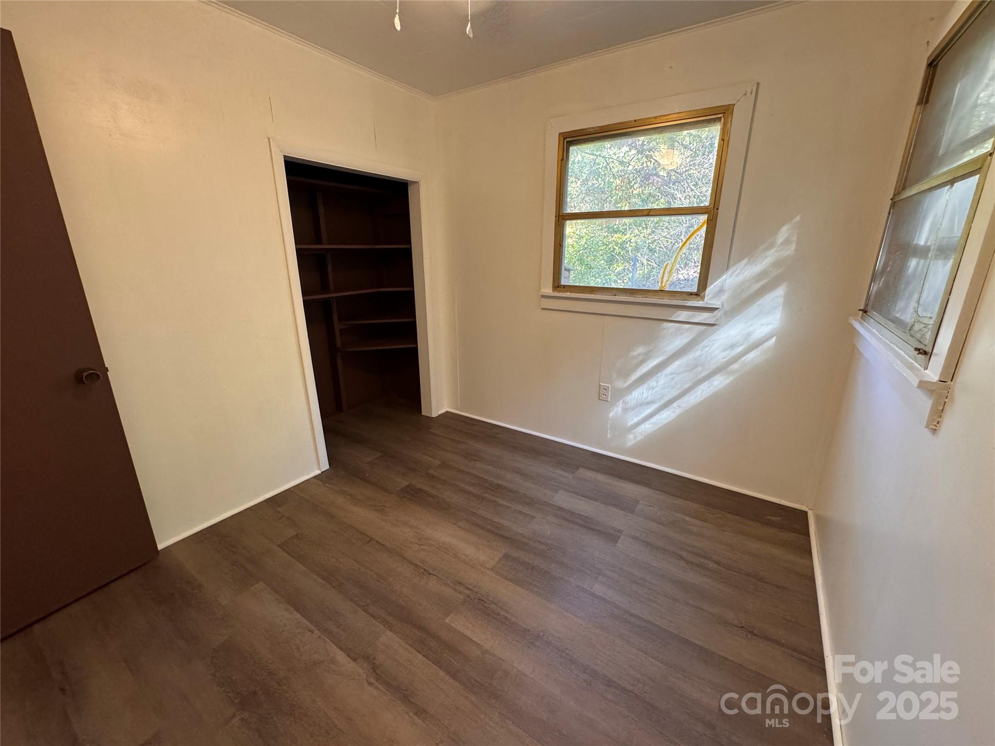84 Pelohi Cove Road Bryson City, NC 28713 - Photo 10 of 22 a view of an empty room with wooden floor and a window