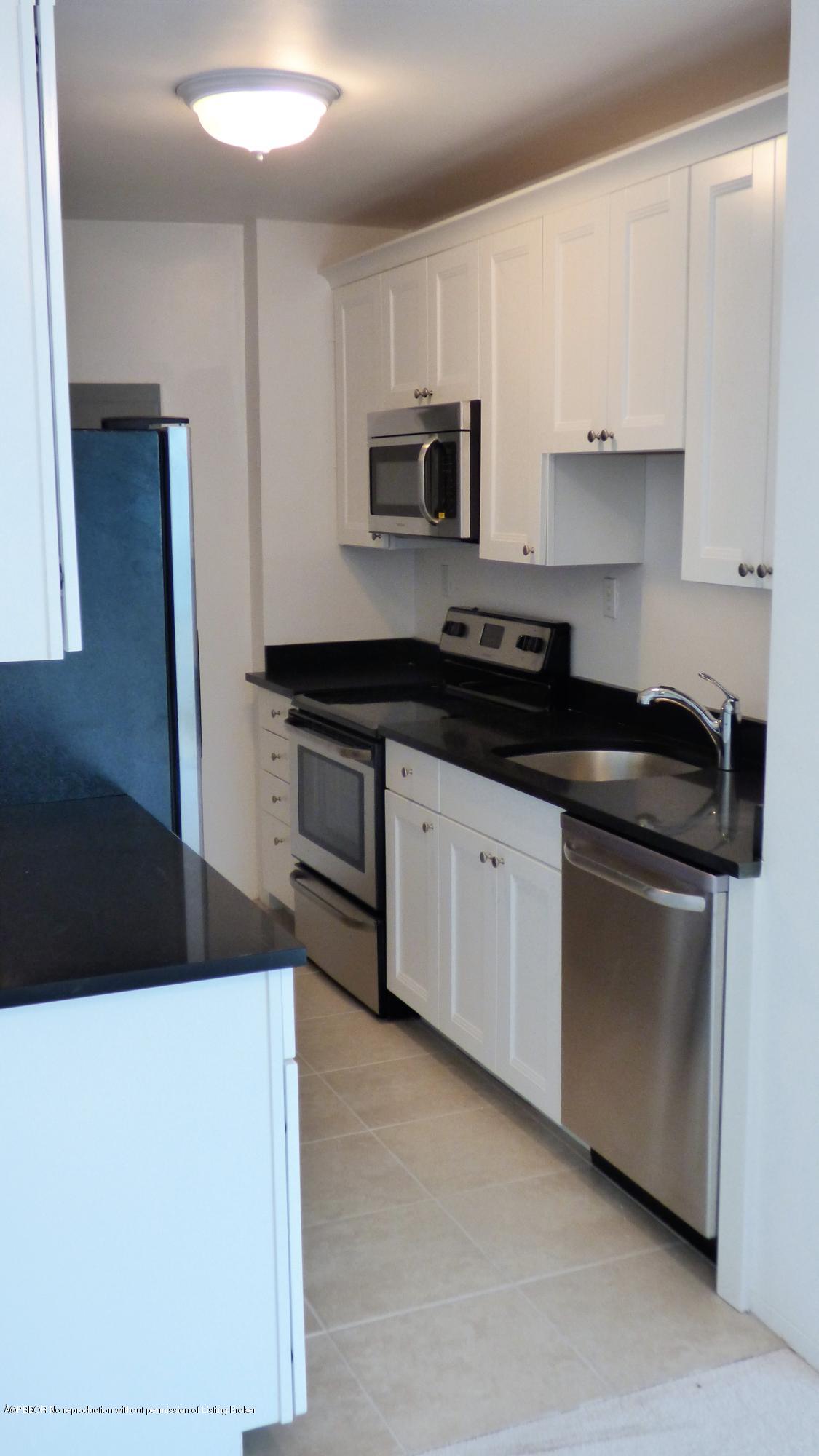 44 Cocoanut Row, Unit 308B Palm Beach, FL 33480 - Photo 6 of 14 a kitchen with stainless steel appliances granite countertop a stove a sink and a microwave