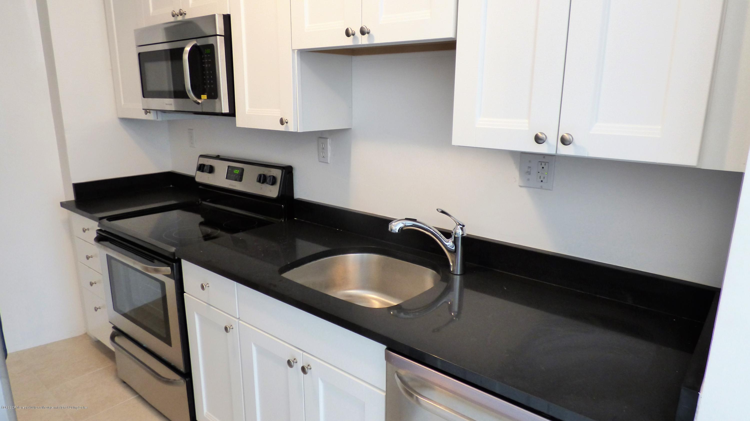 44 Cocoanut Row, Unit 308B Palm Beach, FL 33480 - Photo 8 of 14 a kitchen with a sink and a stove
