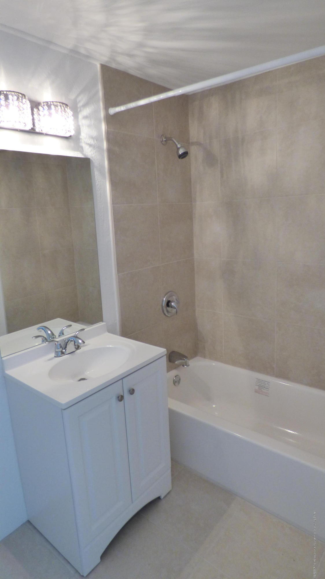 44 Cocoanut Row, Unit 308B Palm Beach, FL 33480 - Photo 9 of 14 a bathroom with a sink a mirror and a bathtub
