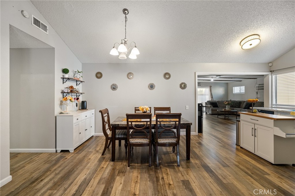 638 Eston Place Lancaster, CA 93535 - Photo 11 of 44 a view of a dining room with furniture and wooden floor
