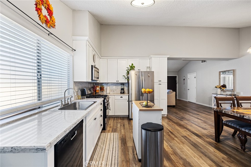 638 Eston Place Lancaster, CA 93535 - Photo 15 of 44 a kitchen with a sink stove and wooden cabinets