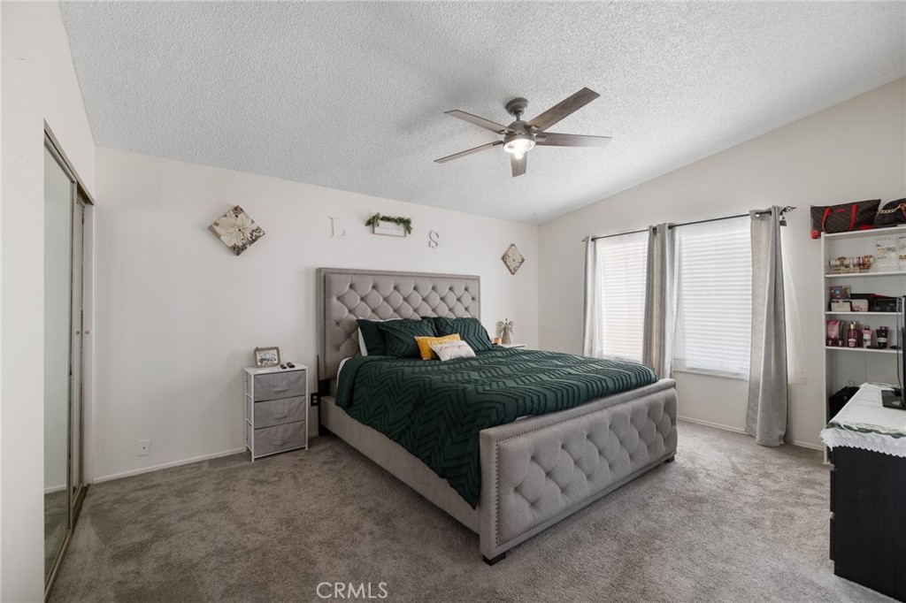 638 Eston Place Lancaster, CA 93535 - Photo 21 of 44 a bedroom with a bed and a ceiling fan