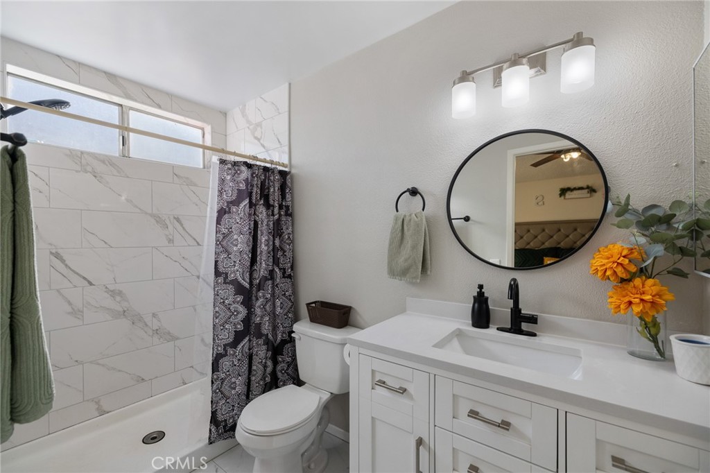 638 Eston Place Lancaster, CA 93535 - Photo 23 of 44 a bathroom with a toilet a sink and mirror